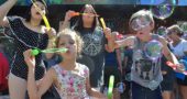 The sixth annual Bubblefest attracted bubble-blowers from near and far. Here local resident Ginger Spaugy enjoyed some good clean fun with her grandchildren, from left, Rayna, Jaidyn and Vanny. (Photo by Megan Bachman)