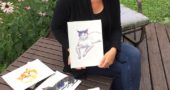 Local author, illustrator and English professor Kate Polak recently showed off some watercolor paintings of cats as part of a children’s book project. Polak recently authored, “Ethics in the Gutter: Empathy and Historical Fiction in Comics.” (Photo by Carla Steiger)