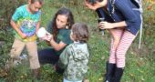 At a recent Forest Family session of the Nature Connect outdoor school, Emily Foubert looked closely at a puffball mushroom with Zander Breza, who had spotted the mushroom. Looking on are Meredith Carpe and daughter Havah, age 2. The program, Mondays from 9 to 10:30 a.m., is open to children 5 and under with an adult. Foubert, who grew up in Yellow Springs, is fulfilling her dream of opening up an outdoor school for children. Tuesday sessions for home-schooled children are also offered. (Photo by Diane Chiddister)