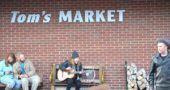 During a busy and beautiful holiday weekend in Yellow Springs, a street busker entertained holiday shoppers while villagers went about their regular business. (Photo by Megan Bachman)