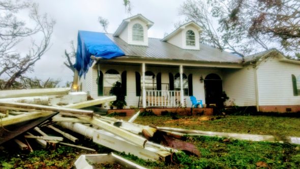 Aftermath: my parents’ front yard and the remains of part of their porch mingled with those of an unidentified boat house.