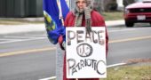 Longtime villager Peg Champney stands at the corner of Livermore Street and Xenia Avenue, part of an ongoing peace protest that has been raising awareness to passersby for more than 15 years. (Submitted photo by Luciana Lieff)