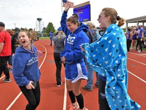 Girls track athletes, from left, Sophia Lawson, Jude Meekin and Natalie Galarza celebrated the girls team’s first-place win at the Metro Buckeye Conference championship Saturday, May 11. (Photo by Kathleen Galarza)