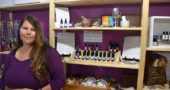 Stephanie Palmer, the only registered aromatherapist in Ohio, will open the doors of Awaken Essential Oils to the public beginning June 8. In addition to her wide array of hand-blended and fragrant oils, Awaken Essential Oils offers a diverse collection of tea blends, gemstones, crystals, incense, jewlery and an assortment of spiritual tools. Here, she holds a pearly hunk of apophyllite. (Photo by Reilly Dixon)