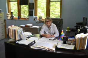 Patti Bates departs the Village’s top job at the end of June. The outgoing Village manager recently sat at the desk where she worked for the last five years. (Photo by Megan Bachman)