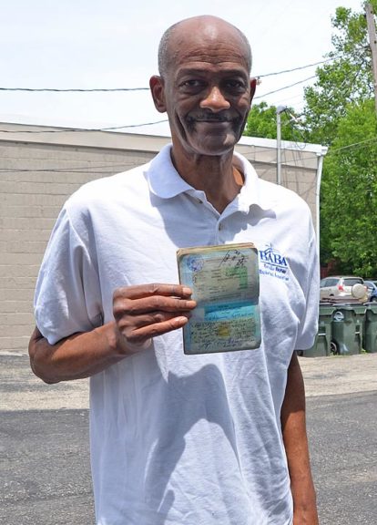 Former pro basketball player and coach Sterling Wright shows off his well-traveled passport. (Photo by Audrey Hackett)