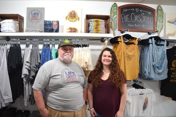 The father-daughter team of Mark and Morgan Heise opened the doors to Yellow Springer Tees & Promotions on June 3. Three weeks and one Street Fair later, the business is doing better than ever as a brick-and-mortar shop. (Photo by Reilly Dixon)