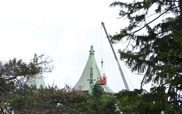 A worker went atop Antioch College’s Main Building Wednesday, July 3, to repair wind damage. See sidebar on page 7 for more on its restoration. (Photo by Megan Bachman)