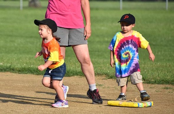 Ella Bristline, 3, took off for the base, leaving Topher Besson, 3, on the bag and in the dust on Friday's Perry League T-ball game. (Photo by Luciana Lieff)
