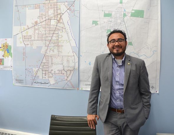 New Village Manager Josue Salmeron, pictured here in his office, has had a busy first month on the job. “You realize you have so may things going on, so many things to address,” he said. “It takes your breath away.” (Photo by Megan Bachman)