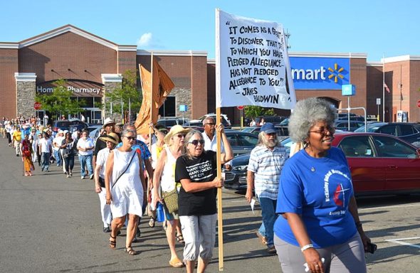 On a hot Monday evening, at least 100 people gathered outside the Beavercreek Walmart for a memorial on the fifth anniversary of John Crawford III’s shooting death at the store. The event was organized by villager Yolanda Simpson. While police were not indicted for the killing, a civil trial related to the incident is due to start in Dayton, on Oct. 28. (Photo by Audrey Hackett)