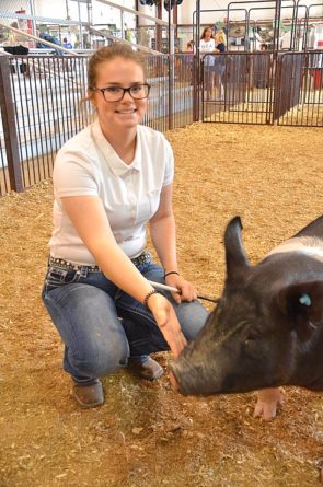 Longtime 4-H participant Amanda Everett posed with her hog, Floyd (as in “Pig Floyd”) at the Greene County Fair. Floyd won third place in his class in the market hog competition this year. Everett is one of dozens of youth from across the county who participate in livestock competitions through 4-H and FFA at the Greene County Fair every summer. (Photo by Lauren “Chuck” Shows)