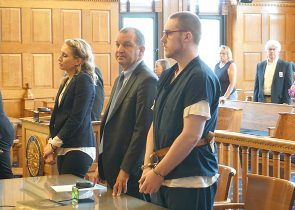 Zyrian Atha-Arnett stood with his defense lawyer, Jon Paul Rion, during his sentencing Wednesday, July 21, in the 2019 stabbing death of Leonid “Lonya” Clark. Atha-Arnett pleaded guilty to involuntary manslaughter as part of a plea deal with the Greene County Prosecutor’s Office, and was sentenced to 15 years in prison for that and other charges. (Photo by Carol Simmons)