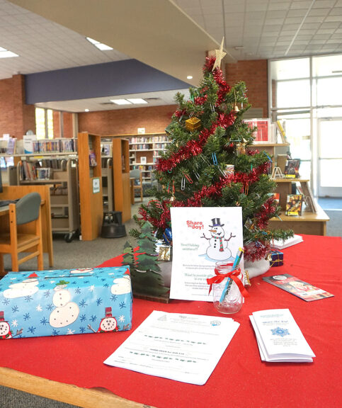 The 2021 Share the Joy holiday tree is now up at the YS Community Library. Requests for gifts will be taken until Sunday, Dec. 5, at 5 p.m. (Photo by Reilly Dixon)