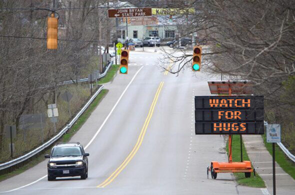 A sign on U.S. Route 68 heading in to Yellow Springs warns unsuspecting visitors to watch their personal space, after Village Council passed the "6 inches of separation" mandate. (Photo by F. Stop Fitzgerald)