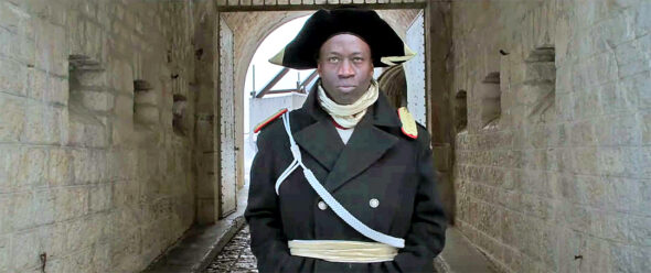 Cincinnati native Napoleon Maddox will present excerpts from musical and spoken word works in collaboration with Tronee Threat and the World House Choir on Thursday, Oct. 13. Maddox is pictured dressed as Haitian Revolution leader Toussaint Louverture at Château de Joux, where Louverture was imprisoned and died. Maddox composed  “L’Ouverture de Toussaint,” a portion of which will be performed in Yellow Springs, about Louverture. 