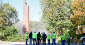 After almost half a day wrangling with the well-constructed smokestack from the decommissioned Antioch College power plant, workers take stock of the demolition process. (Photo by Kathleen Galarza)