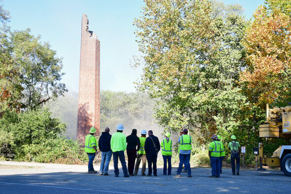 After almost half a day wrangling with the well-constructed smokestack from the decommissioned Antioch College power plant, workers take stock of the demolition process. (Photo by Kathleen Galarza)